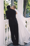 Bride and Groom looking over Railing